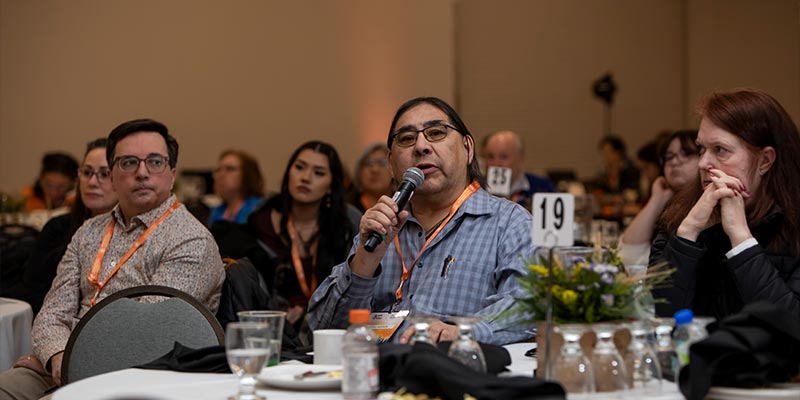 Man speaking into microphone at IHHG