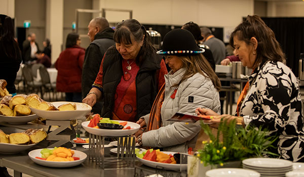 Participants standing in front of a food table
