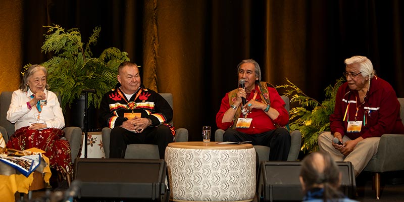 Four Survivors speaking on stage at IHHG